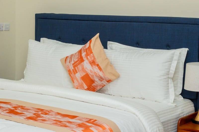 Bedding detail, striped cotton with a patterned cushion