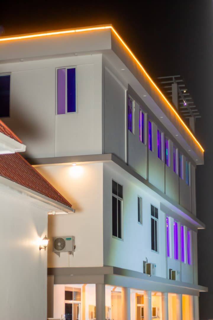 The upper floors of Moonlight Hotel picked out in coloured light