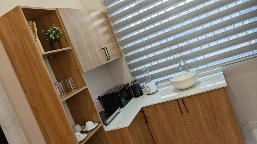 Kitchenette with worktop, sink and storage